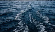 Boat wake on blue water